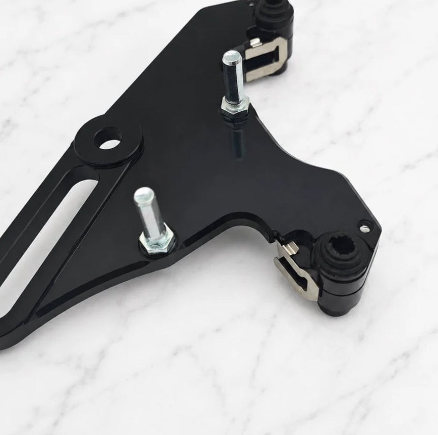 Tuttio foot brake kit close-up view showing precision-machined components and sleek black finish.