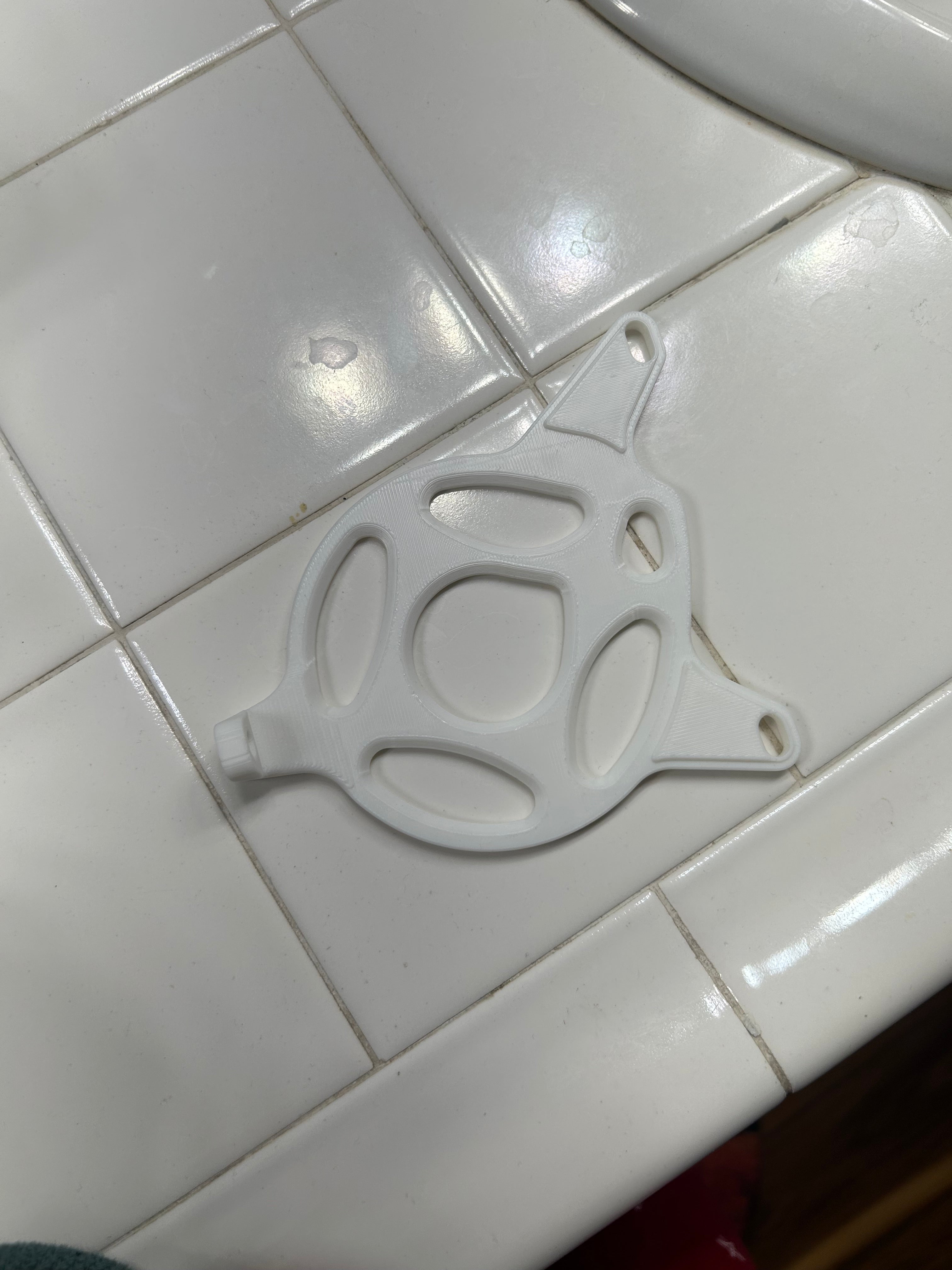 3D printed motor cover for Tuttio Soleil 01 lying on a tiled surface, showcasing its durable and custom design.