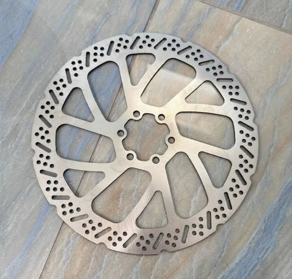 240MM motorcycle brake rotor for high-performance electric dirt bikes on a textured surface.