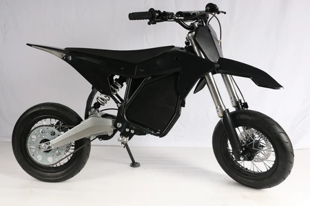 12 inch supermoto wheel set displayed on a sleek black ETM RTR bike, showcasing agile design and performance.