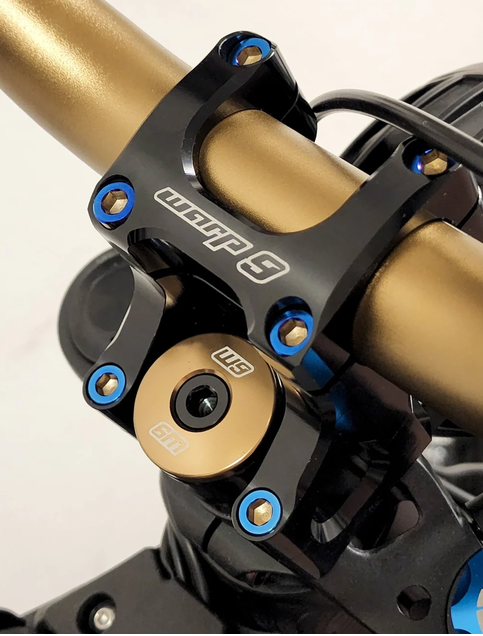 Titanium bar mount bolt kit installed on a bike stem with Burnt Blue accents for enhanced durability.