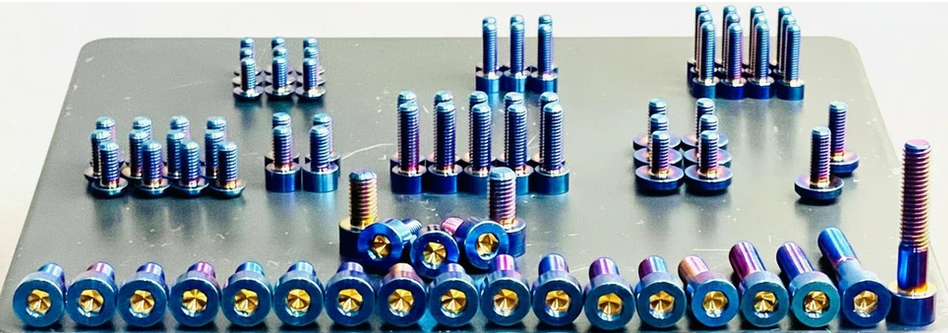 titanium full body kit featuring aerospace-grade titanium fasteners in various sizes and colors on a display tray.
