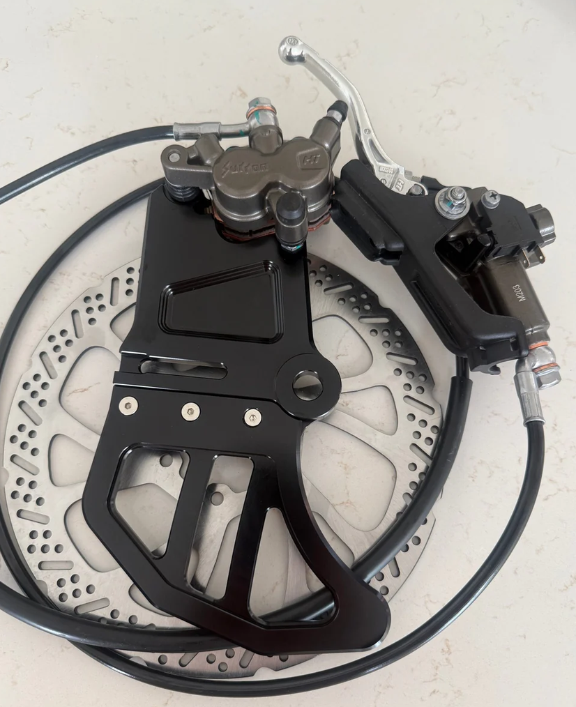 OEM brake kit for Talaria MX5 featuring high-performance brake calipers and rotor.