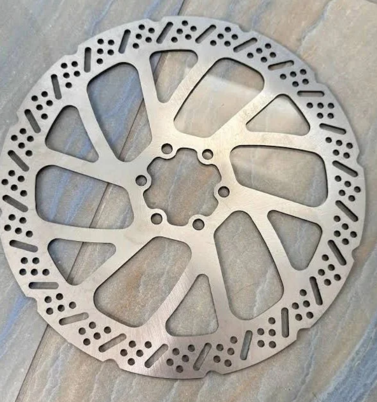 240mm rear brake rotor for Surron E-Moto on a textured surface