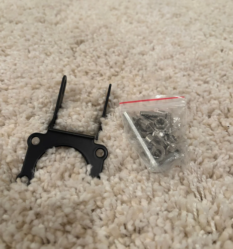 Talaria Baja light plug and play installation bracket and screws kit on carpet.